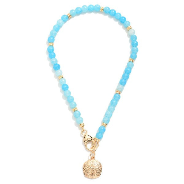 Beaded Necklace Featuring Metal Tone Sand Dollar & Clasp Pendant