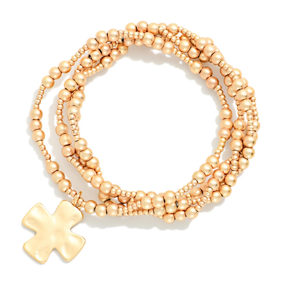 Set Of Four Metallic Beaded Stretch Bracelets Featuring Plus Cross Charm